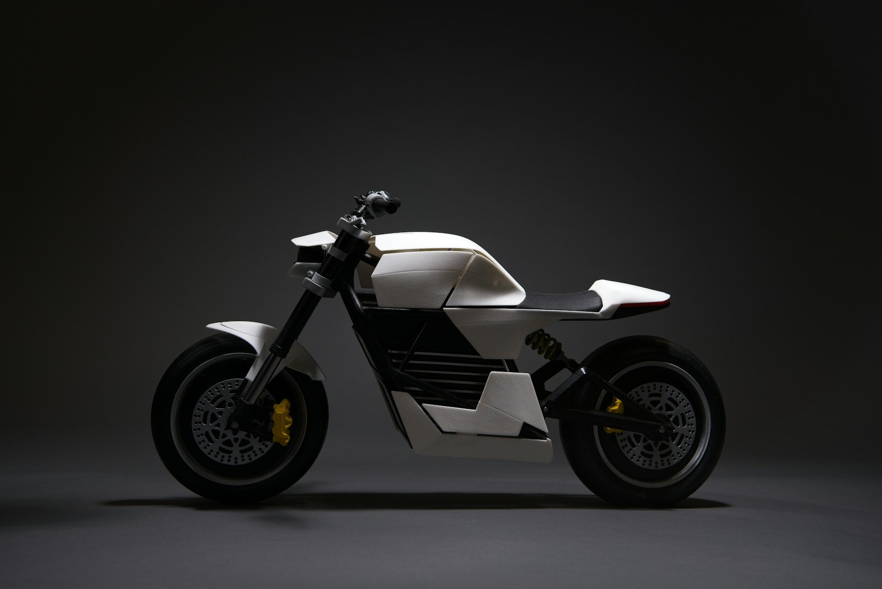 white and black motorcycle with black background